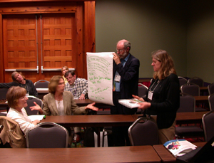 Kip Cates holds poster paper as his group reports out