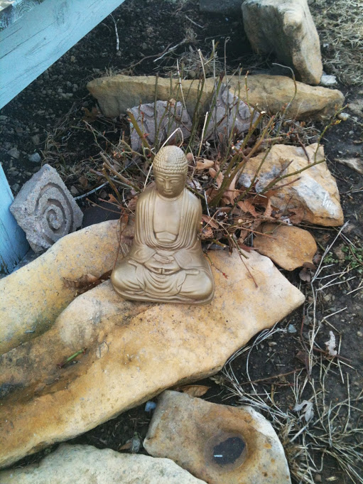 Photo of a stone Buddha statue off Kirk Auston's porch at his place near Pomona